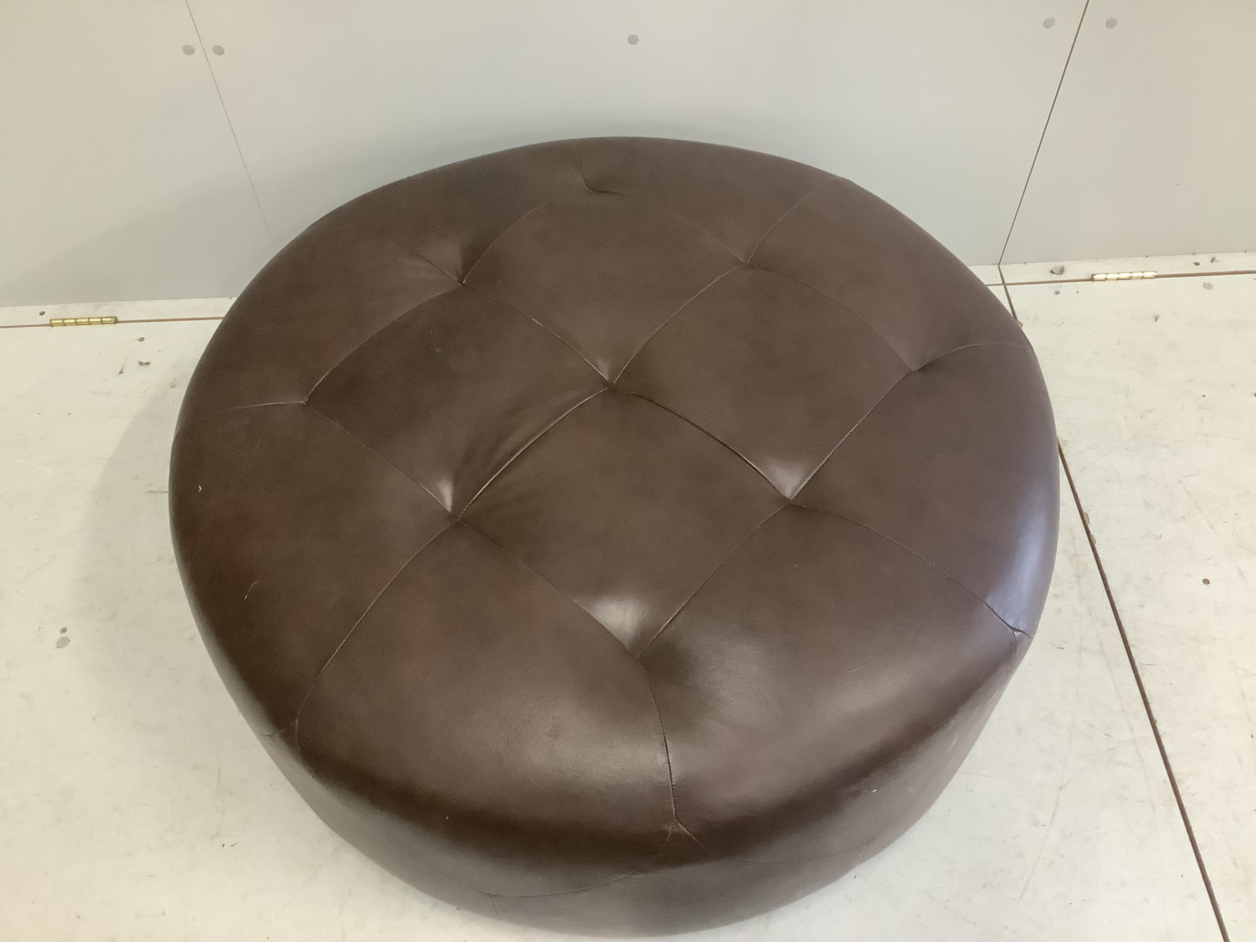 A circular brown leather footstool, diameter 100cm, height 36cm. Condition - good